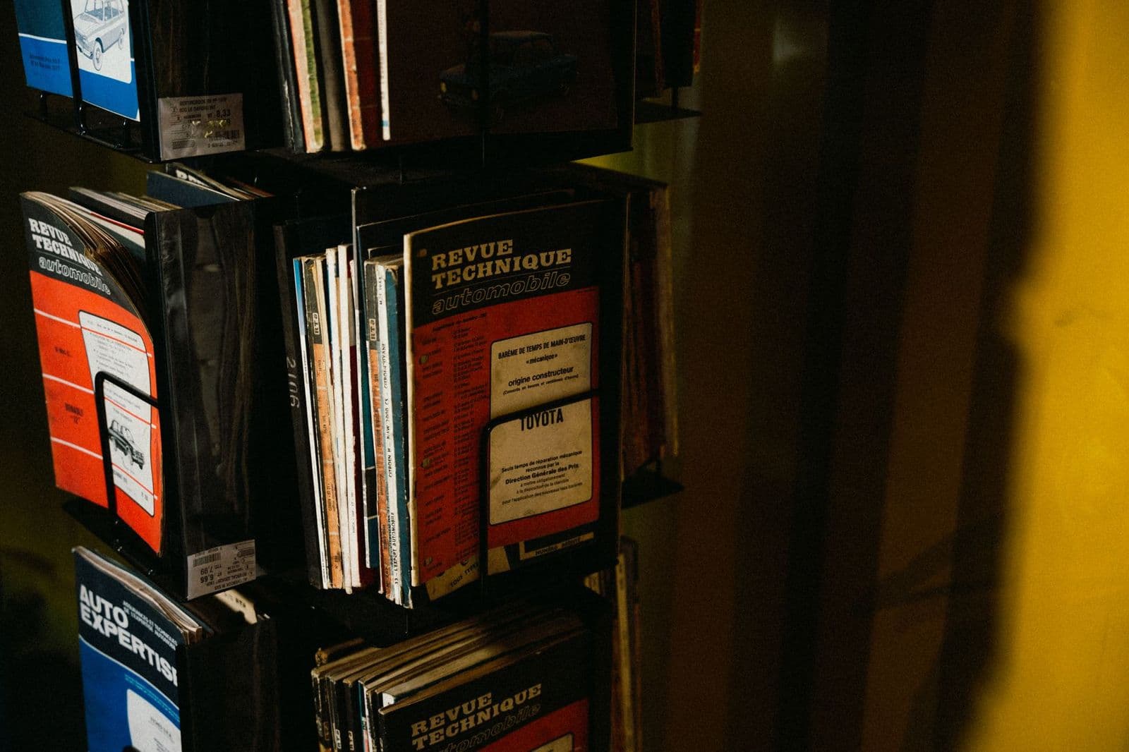 Best auto mechanic books on a garage workbench