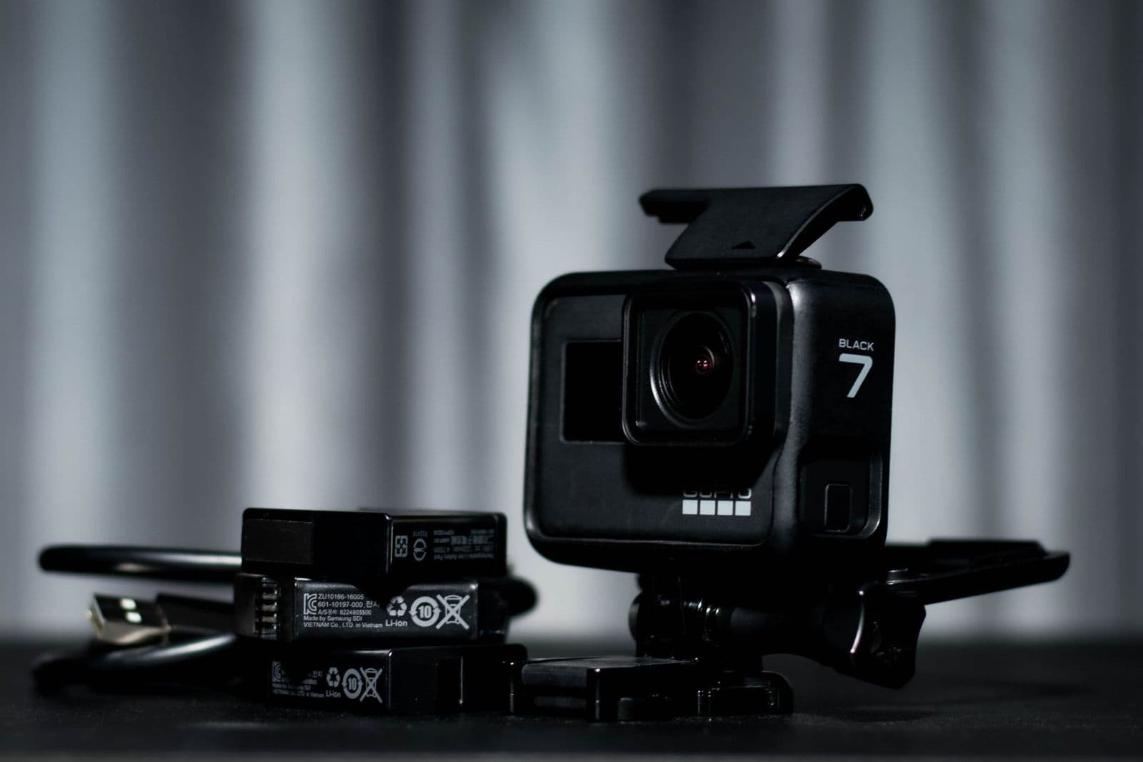 Best batteries for game cameras: AA cells beside a trail camera