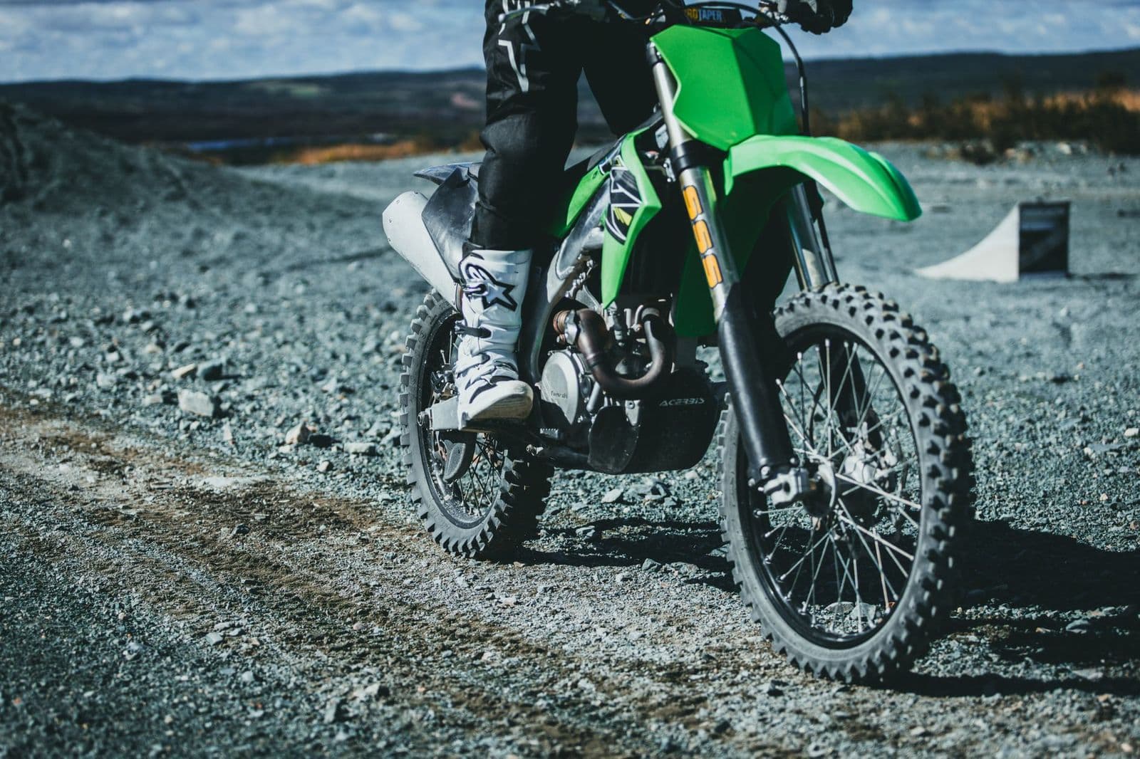 Pair of best biking boots for cycling next to a bike pedal