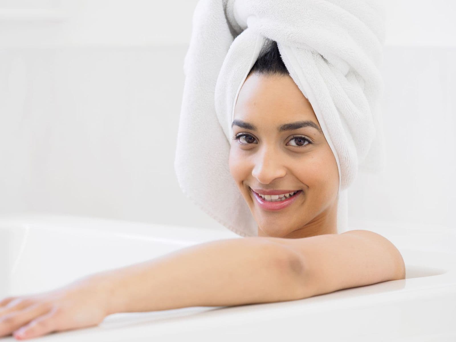 Folded gray cotton towels, the best antimicrobial bath towels, stacked on a bathroom shelf